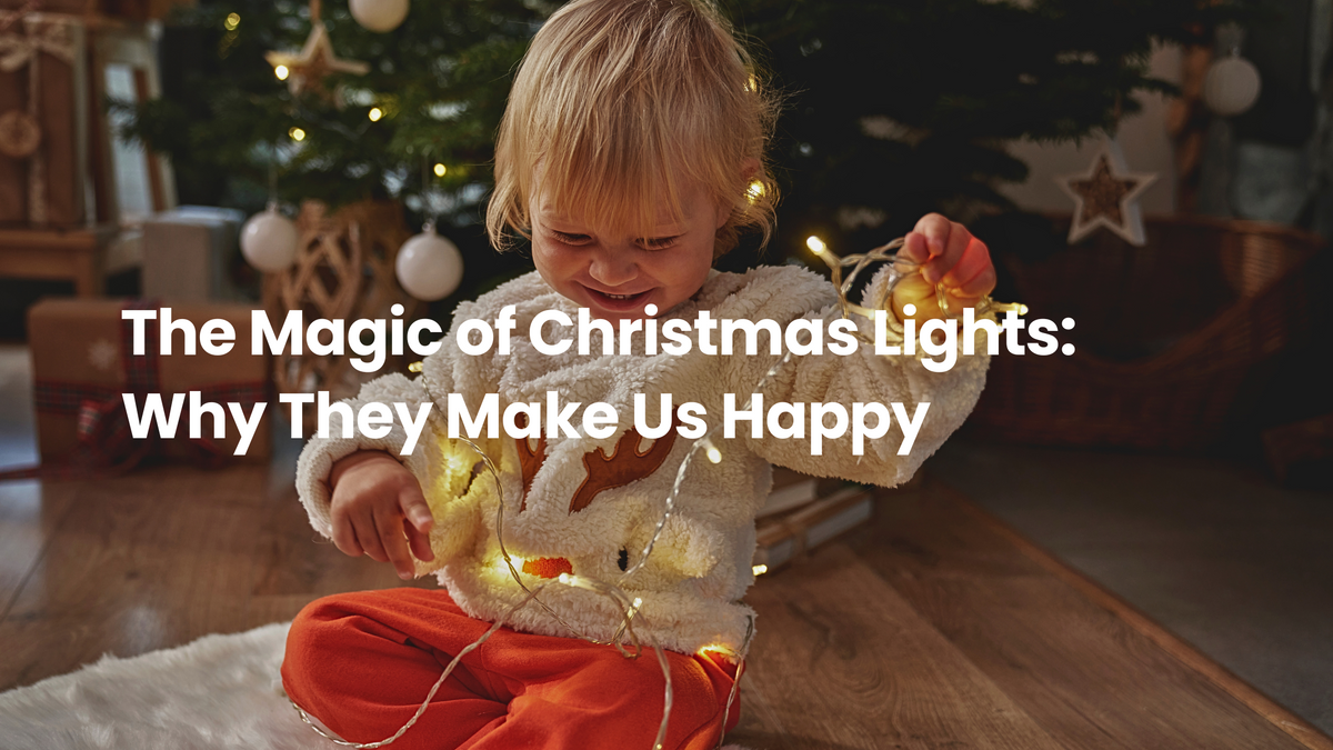 Smiling child sitting by a Christmas tree wrapped in warm string lights, capturing the joyful and cozy magic of holiday lighting at home.