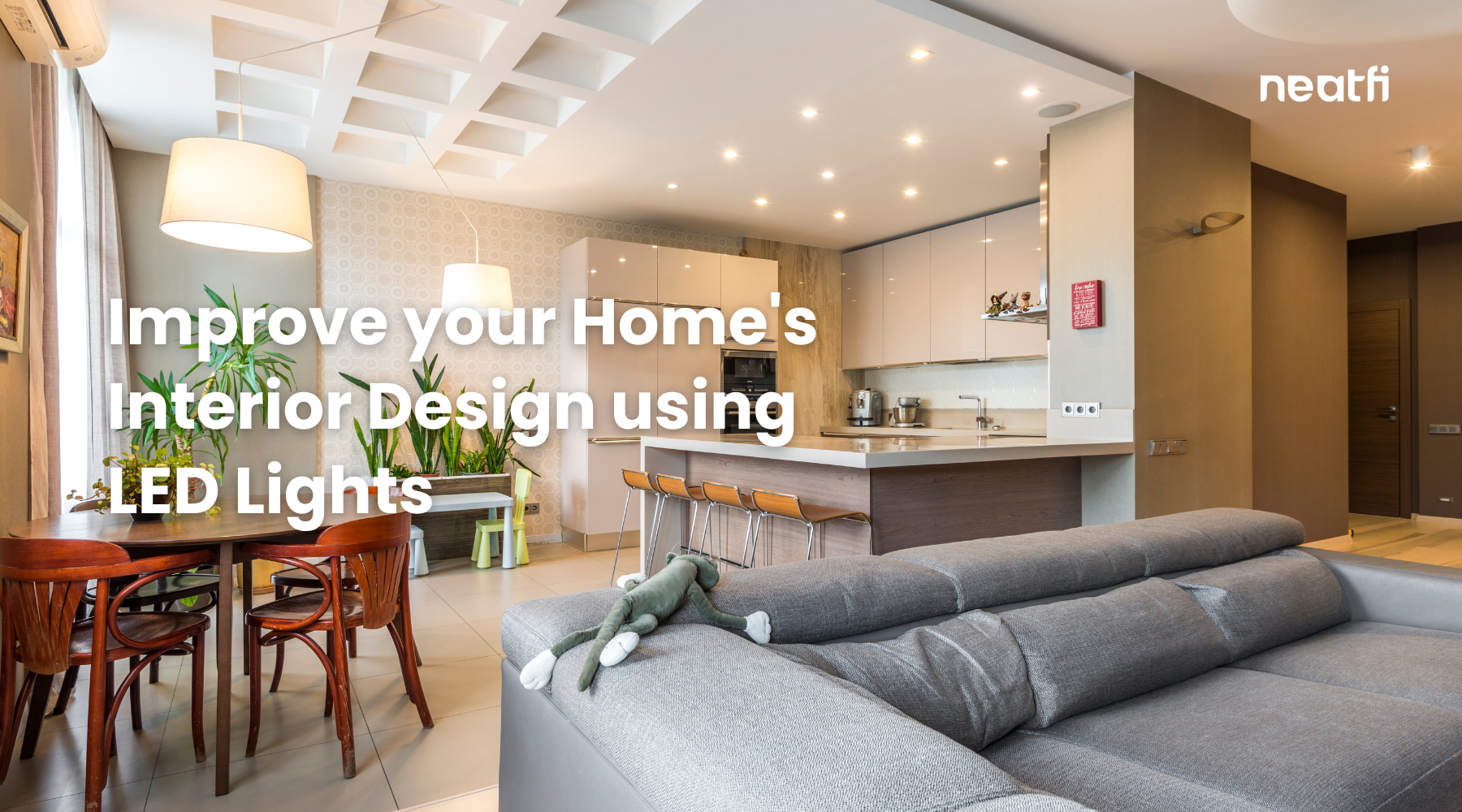 Modern open-concept living room and kitchen with recessed LED lighting, showing how LED lights enhance home interior design and ambiance.