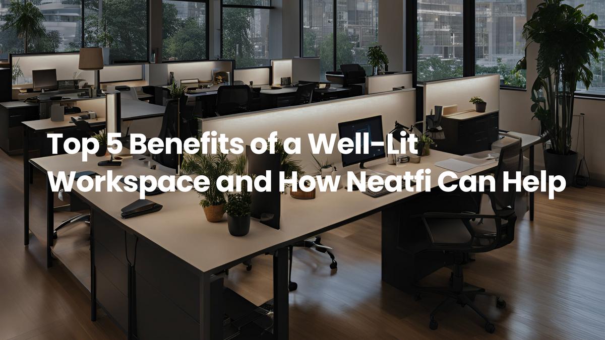 Modern open-plan office with clean desks, computer monitors, soft task lighting, and large windows, illustrating the benefits of a well-lit workspace for comfort and productivity.