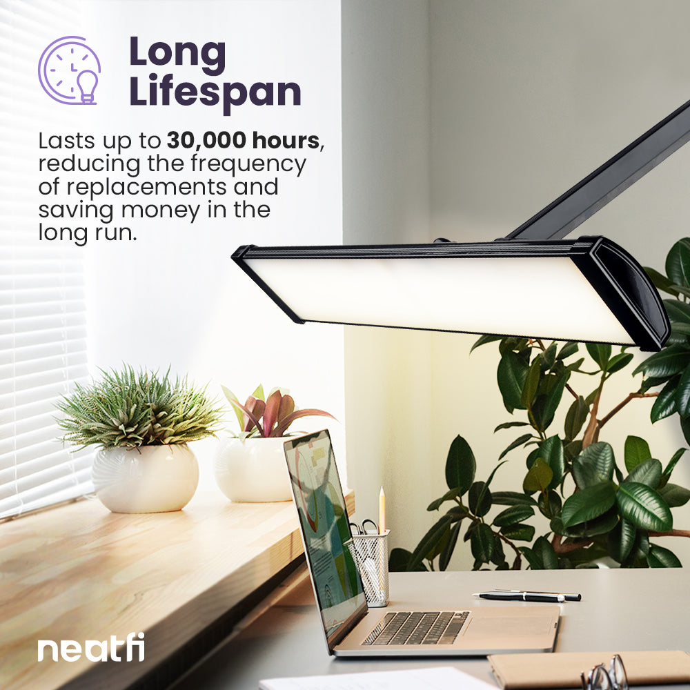 26-inch black LED desk lamp with wide shade illuminating a modern workspace, designed for long-lasting LED use up to 30,000 hours.